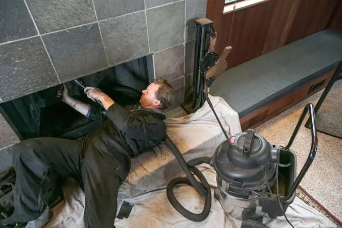 Clean residential fireplace after chimney care